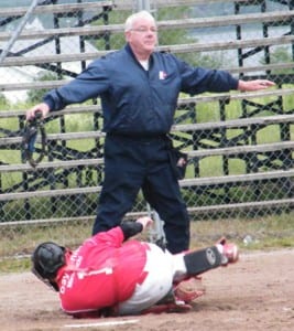 Umpire Pete McLean makes the call at home plate, as the Rangers score another on the way to a 12-8 victory.