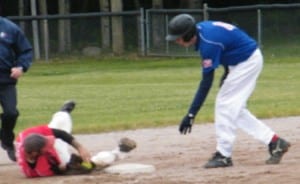 Rangers' player Cory Cooper bowls over Red Sox' second baseman Brett Goodin in a close play.