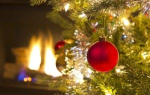 Bright red Christmas ornament hanging on Xmas Tree