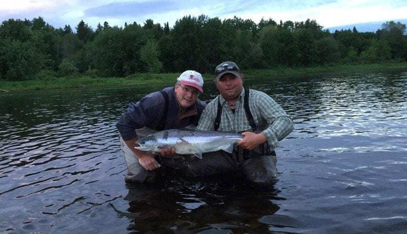 Stephen Leger with a nice June salmon, accompanied by guide Derek Munn.