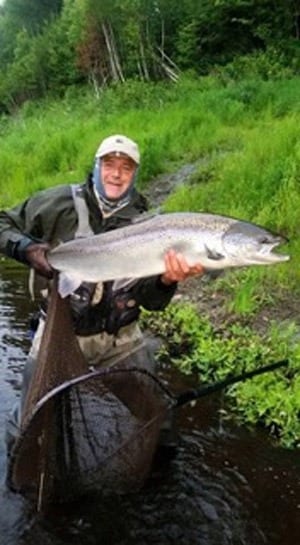 Steve Smith of the Miramichi Fly Fishing School with a beauty caught on a dry fly (blue bomber) on the night of the 24th near Blackville on the Main SW. 