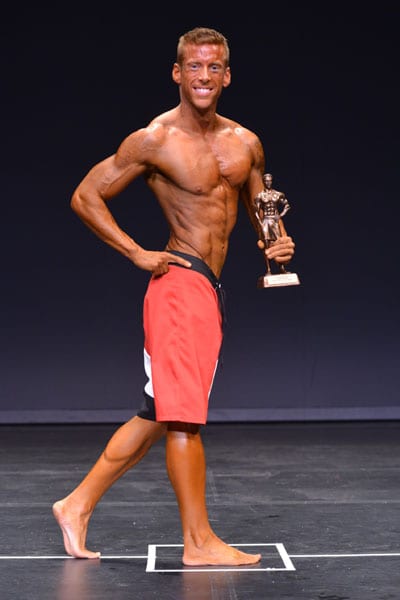 Adam Hambrook, owner of Sculpt Health & Fitness Miramichi being awarded NB Provincial Champion 2015 Men's Physique Short.