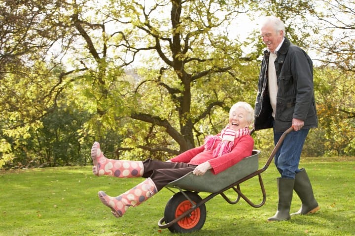 senior-couple-laughing-wheelbarrow-Small